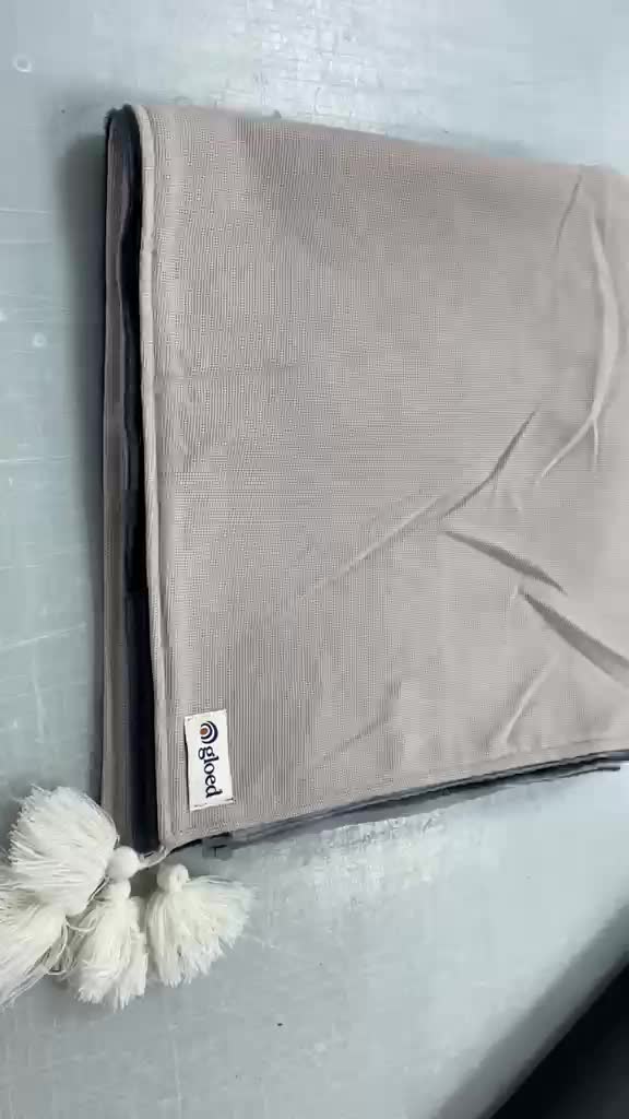 GLOED heated wrap blanket with its woven brand label, shown in supplier footage